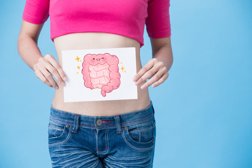 Woman Holding Picture of Smiling Cartoon Intestines Over Stomach Healthy Digestion Concept