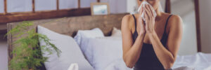 young woman feeling sick with cold & Flu, blowing nose