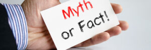 man holding card that says myth or fact