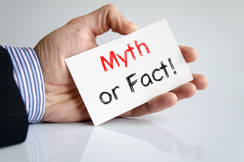 man holding card that says myth or fact