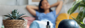 woman relaxing on a coach while essential oil aroma diffuser humidifier the air in living room at home