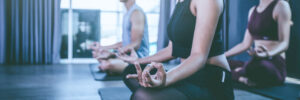 Yoga group concept; young people practicing yoga in class; feeling Calmness and relax in yoga class