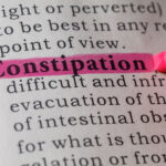 Dictionary definition of the word constipation highlighted in pink.