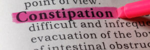 Dictionary definition of the word constipation highlighted in pink.