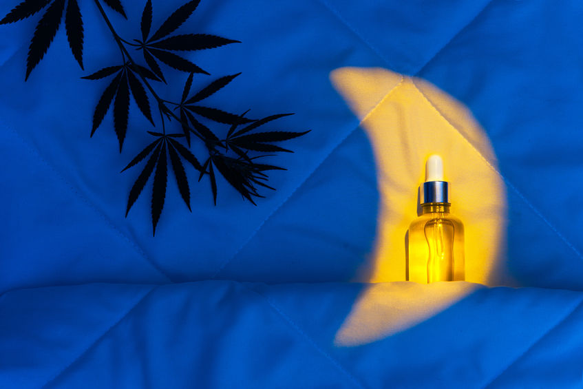 Evening bedroom with cbd oil, capsules and hemp branch. The concept of natural treatment for sleep disorders with medical cannabis supplements. Cannabidil oil improves sleep quality