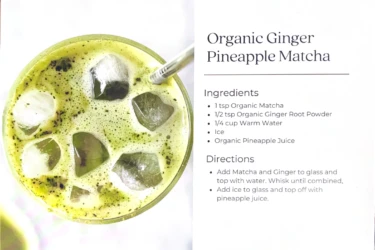 A glass of iced green matcha drink with a metal straw next to a printed recipe for Organic Ginger Pineapple Matcha.